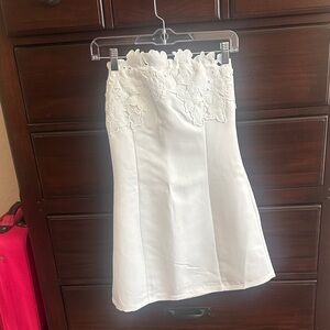 Elegant strapless white mini dress with beautiful embroidered details on the top